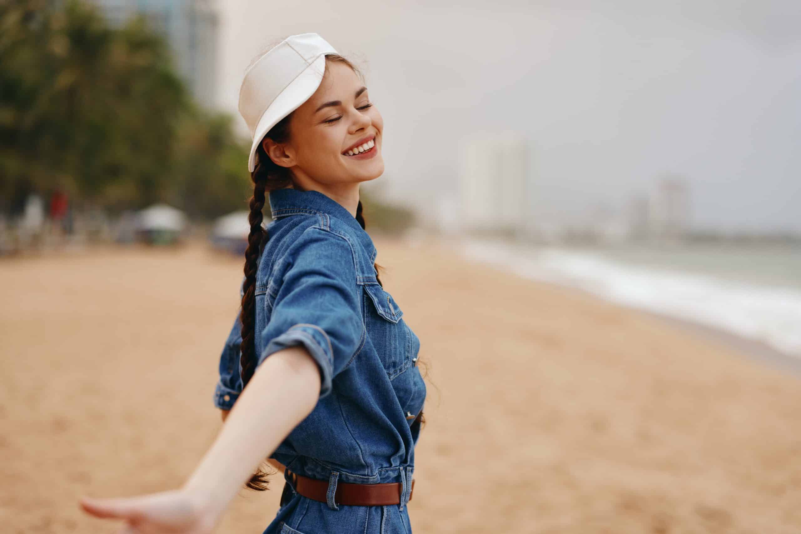 Stylish Summer: Pretty Young Woman, Fashion Model, enjoying Beach Vacation at the Ocean, under Sunny Blue Sky